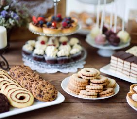table-with-various-cookies-tarts-cakesxc-cupcakes-an-PARM8L9
